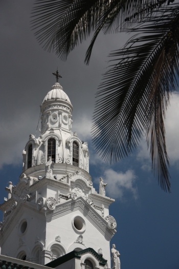 Palm trees and white churches fill Quito's old town.