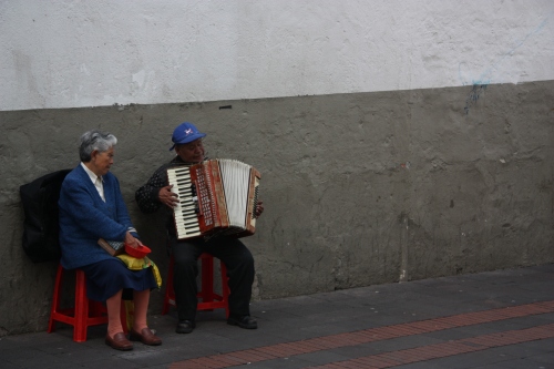 A couple sings and plays accordion in the Old Town streets of Quito