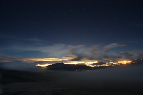 The lights of Quito reflected in the low clouds as seen from camp on Cotopaxi