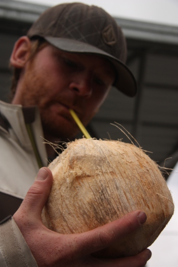 Ben sipping on a fresh cracked coconut